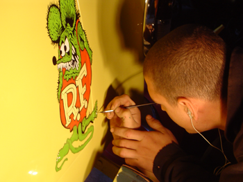 Our staff paint custom artwork on a car.